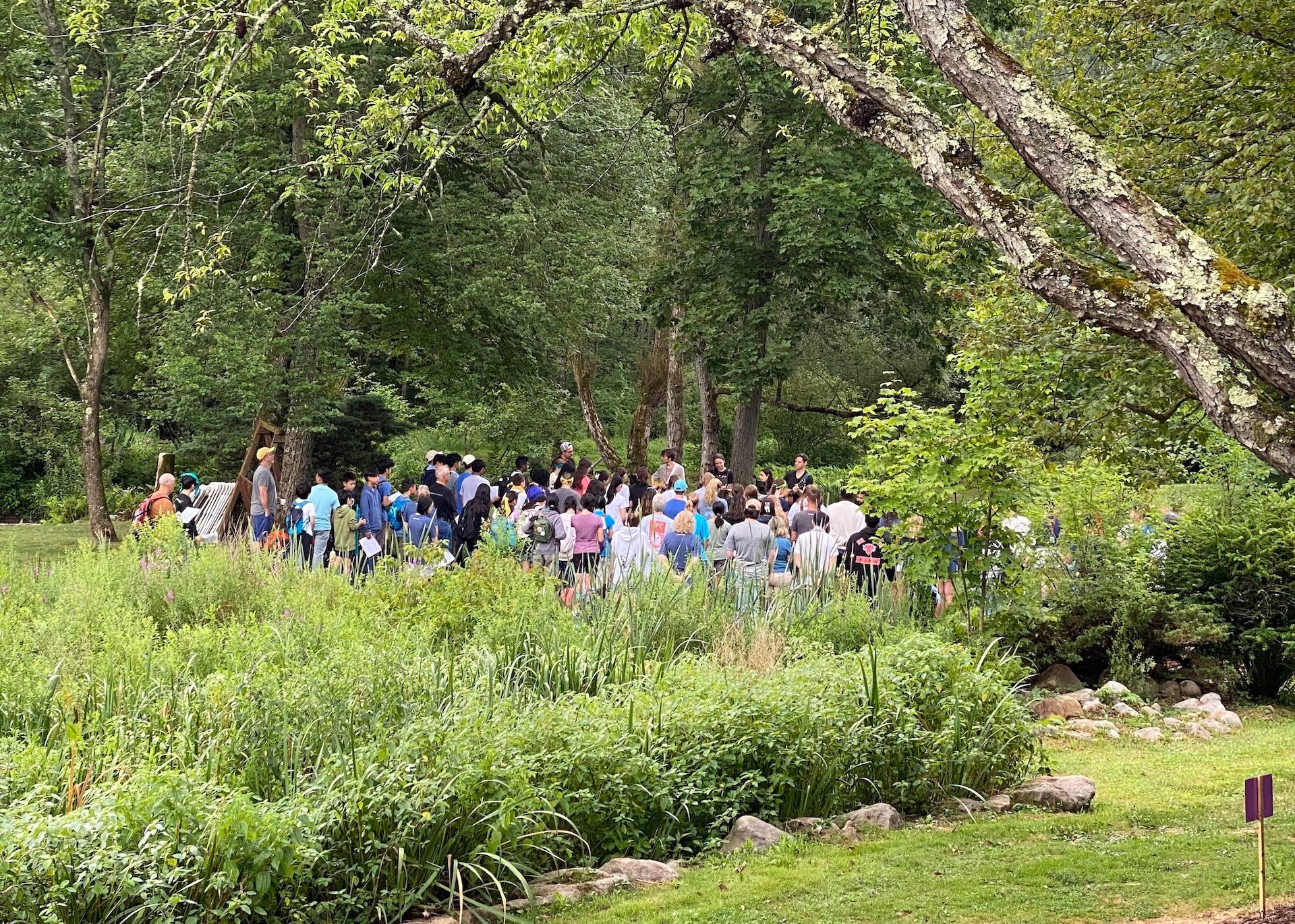 The whole camp gathered for morning worship by the pond at The Mission Center